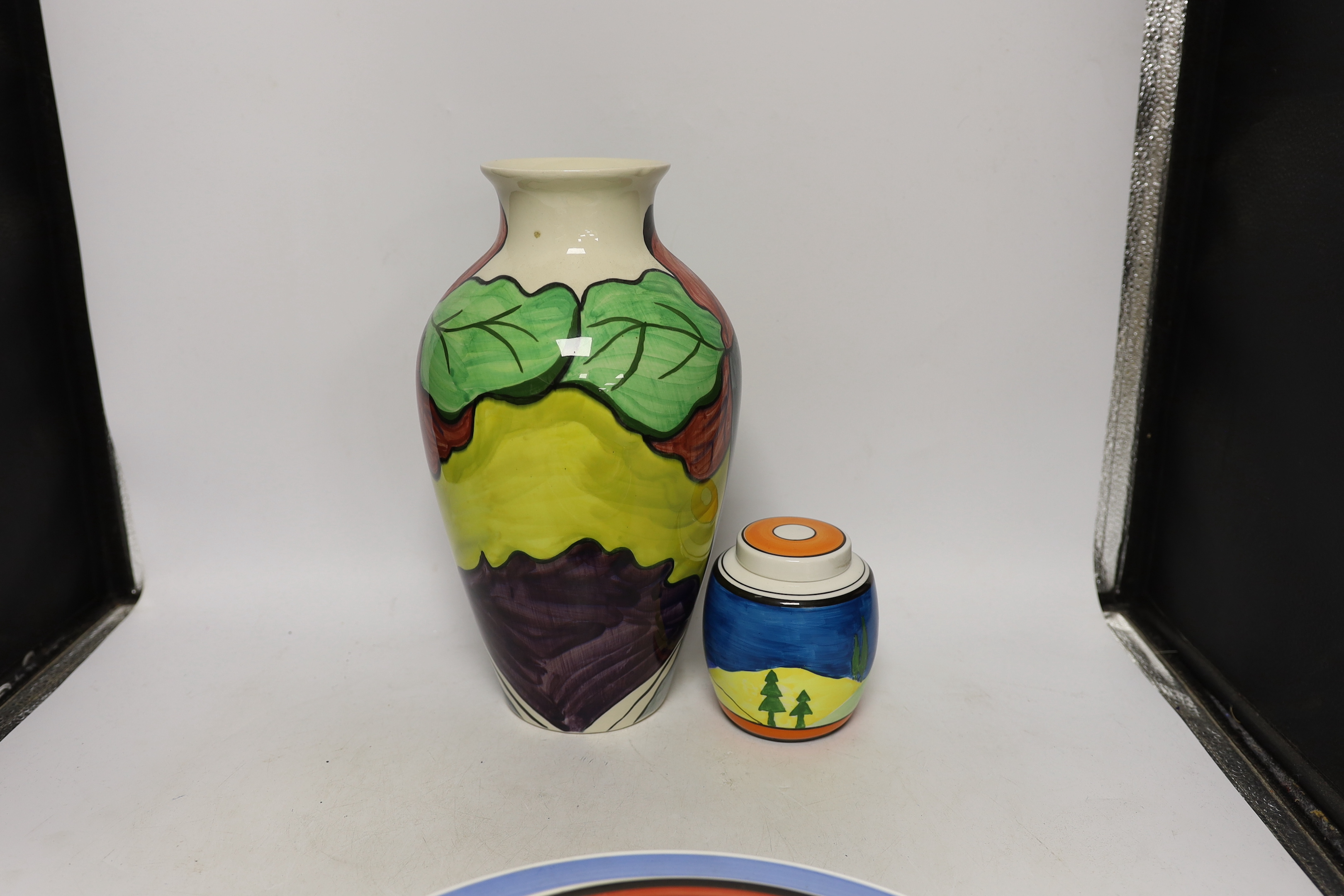 Four Clarice Cliff style plates, a similar vase and a jar and cover, tallest 31cm